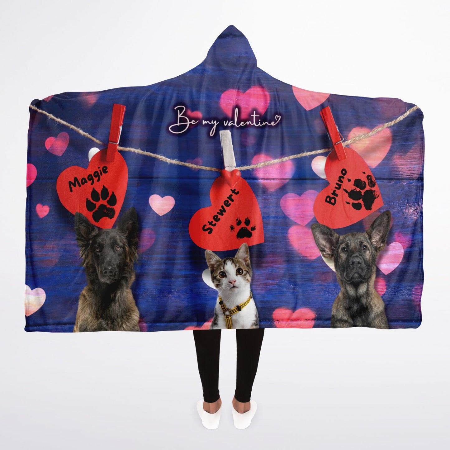 A hooded blanket with a design that includes images of dogs and cats on a red heart background, with personalized text tags.