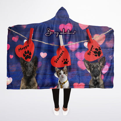 A hooded blanket with a design that includes images of dogs and cats on a red heart background, with personalized text tags.